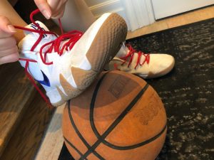 06: She ties up her basketball shoes. Medium close up (Bordwell and Thompson, 189) and canted shot (Bordwell and Thompson, 188).
