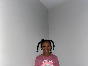 10: Isabella smiling with her freshly braided hair after enduring “wash day”. Two-Point Perspective (Block, 18-21)