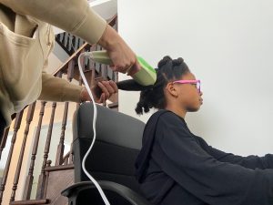 02: My mom using a hair-steamer to detangle the hair before washing it. Low Angle (Bordwell and Thompson, 189) and Size Difference (Block, 27)