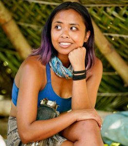 Erika Casupanan sitting in a makeshift shelter on the TV show Survivor