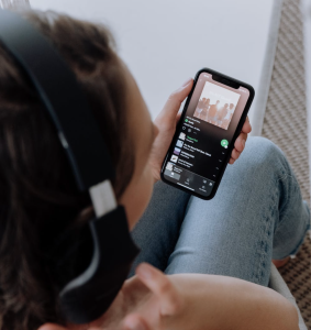 Overhead shot of a person wearing headphones listening to music on Spotify