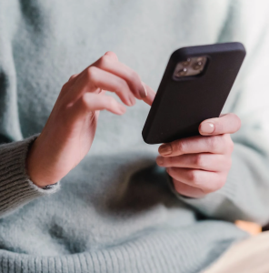 Person scrolling on their iPhone