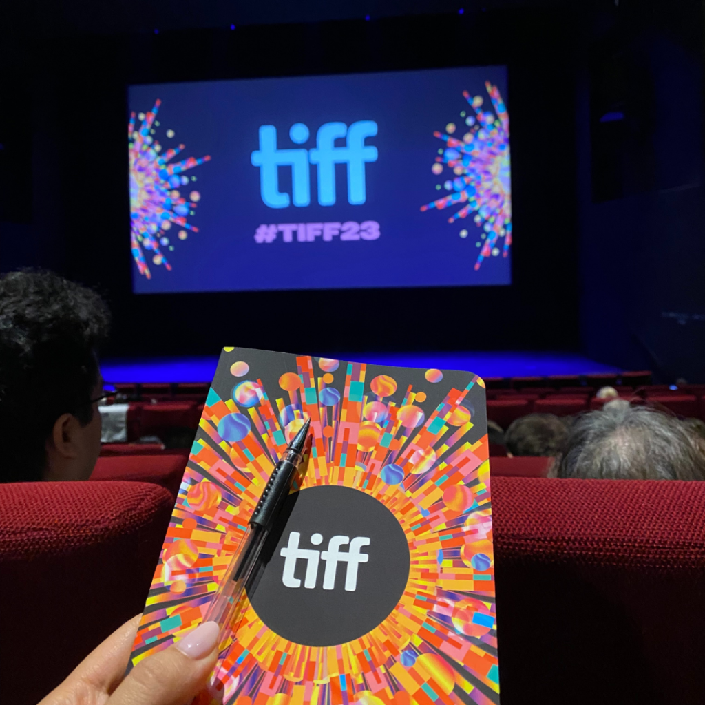 TIFF Note book in forefront with large cinema screen with TIFF logo in background