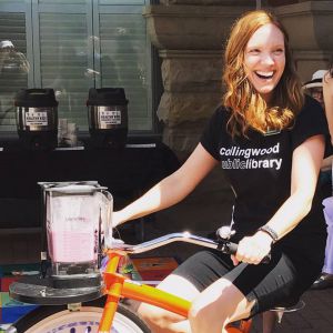 MLIS Grad Named New CEO of Library Ashley Kulchycki on a bicycle