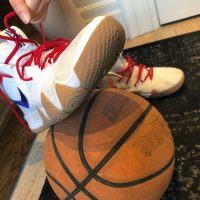 06: She ties up her basketball shoes. Medium close up (Bordwell and Thompson, 189) and canted shot (Bordwell and Thompson, 188).