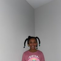 10: Isabella smiling with her freshly braided hair after enduring “wash day”. Two-Point Perspective (Block, 18-21)