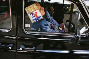 Guardians of Sleep Man resting his head against book in a car